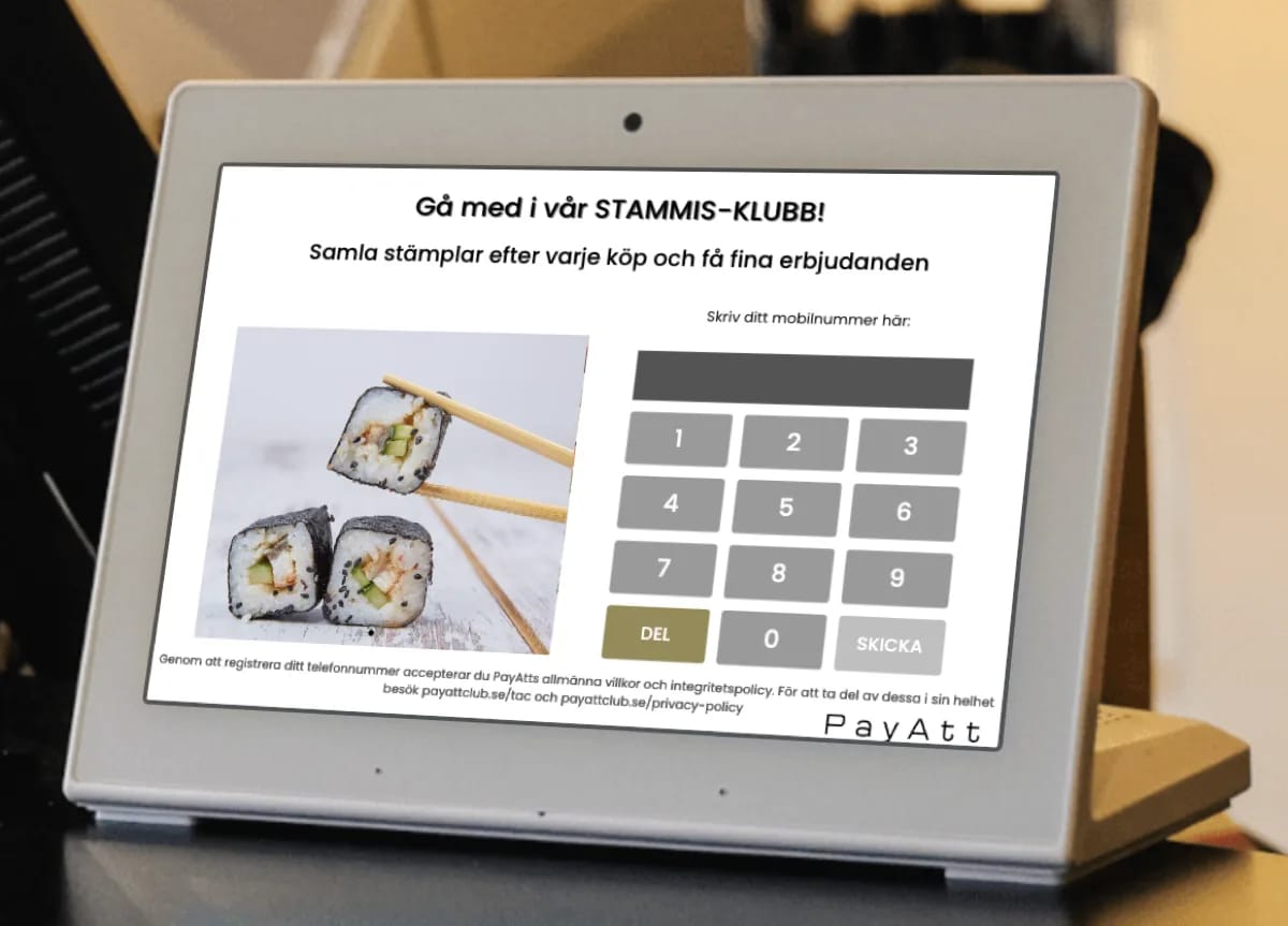 Registreringsskärm i en sushirestaurang — kunden fyller i sitt mobilnummer